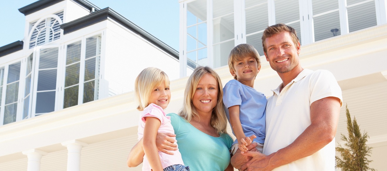 Family standing in front of home - Homeowners Insurance
